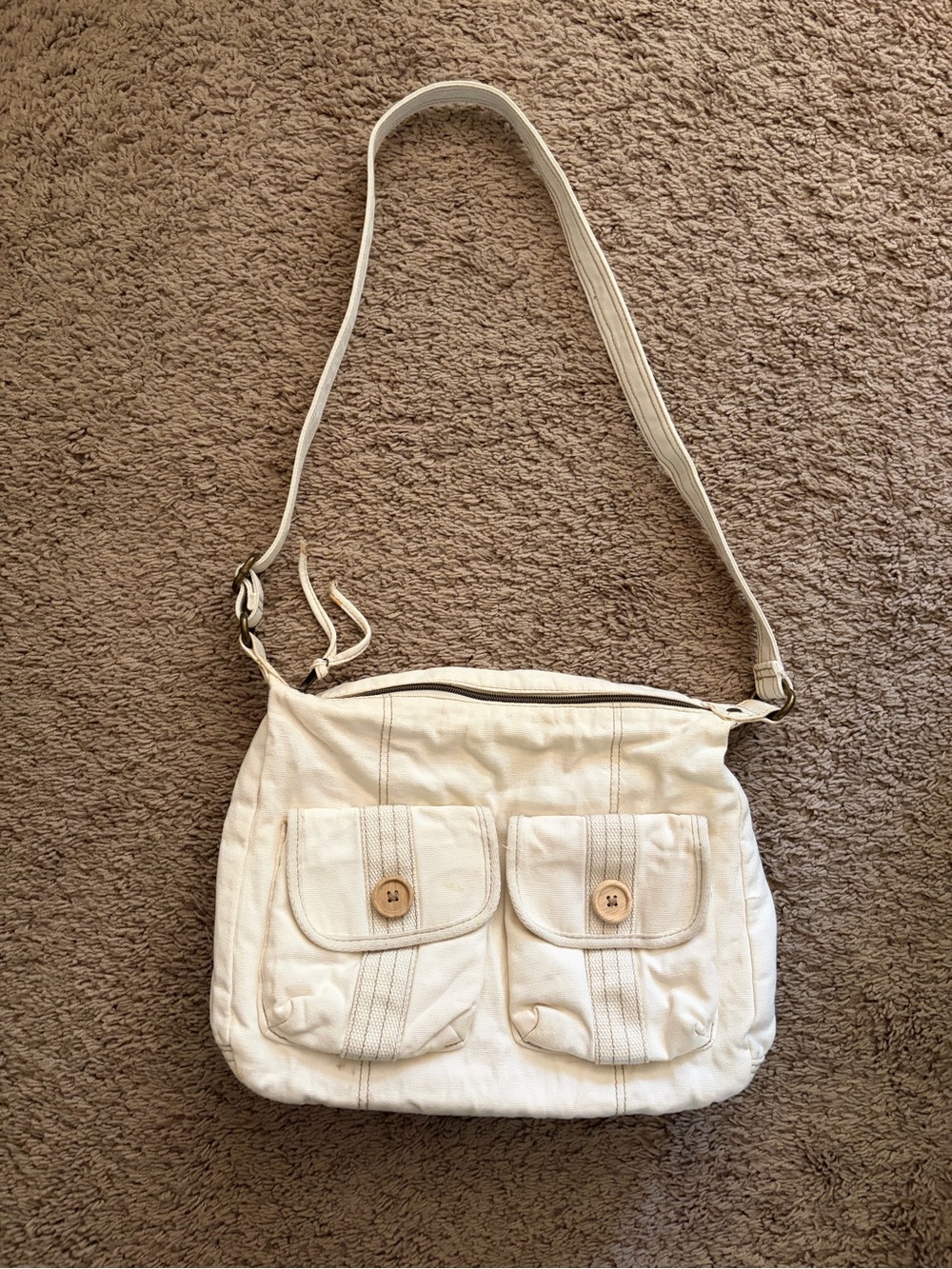 Cream colored canvas crossbody messenger bag